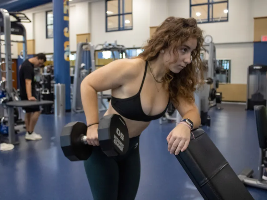 Girl in Black Shirt lifting weights